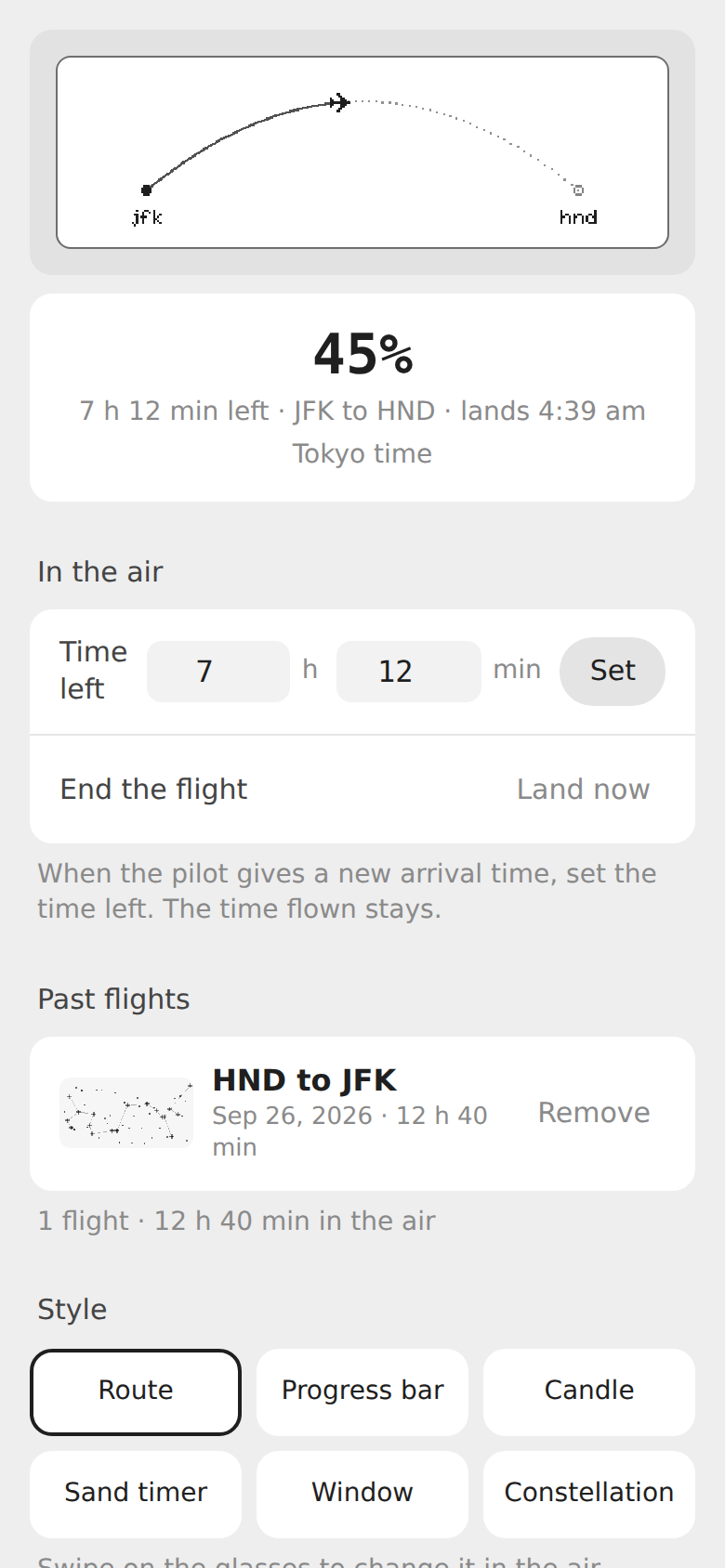 Seatback's phone page in the air: the route mirrored from the glasses, 45%, the time left, the landing time in Tokyo, and a past flight with its constellation.